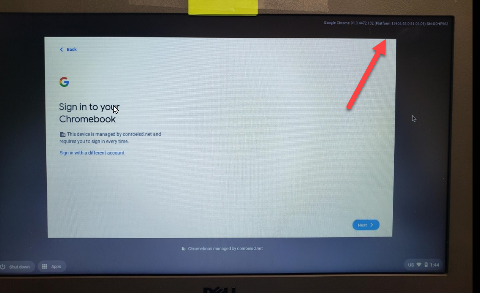 Chromebook login screen displaying ChromeOS version and serial number after pressing Alt and V together on keyboard